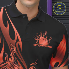 Load image into Gallery viewer, Close-up view of the left chest area of a black polo shirt showing a red gradient tribal flame bowling ball and pins design detail.