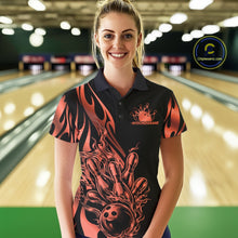 Load image into Gallery viewer, Female model front view in bowling lane wearing black polo shirt with red gradient tribal flame bowling ball hitting pins in energetic action scene.