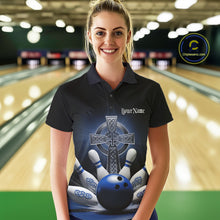 Load image into Gallery viewer, Female model front view in bowling lane wearing black polo shirt with blue Celtic cross and bowling ball exploding into pins artwork
