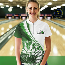 Load image into Gallery viewer, Front view of a female model in a white and green bowling quarter zip with flowing curve graphics and a bowling ball crashing into pins motif at the bowling lane.