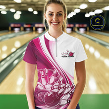 Load image into Gallery viewer, Female model wearing a white and pink bowling quarter zip with dynamic sweeping curves and a bowling ball crashing into pins artwork at the bowling lane.