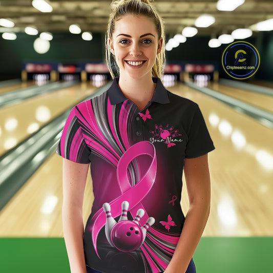 Front view of a female model in a black and pink bowling polo with breast cancer awareness ribbons, small butterflies, and bowling graphics