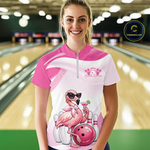 Load image into Gallery viewer, Female model at a bowling lane wearing a pink bowling quarter-zip shirt featuring a stylish flamingo holding a cocktail beside a bowling ball.