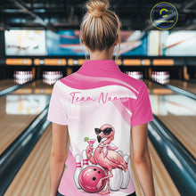 Load image into Gallery viewer, Back view of a female model in a bowling alley wearing a pink quarter-zip bowling shirt with stylish flamingo artwork and a bowling ball motif.