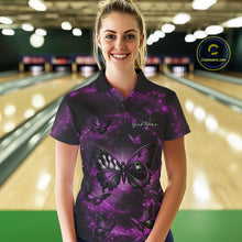 Load image into Gallery viewer, Female model in a bowling venue wearing a bowling polo shirt featuring a purple and black butterfly artwork with a bowling ball body.