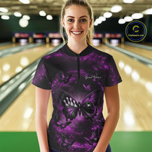 Load image into Gallery viewer, Female model wearing a bowling quarter-zip shirt at the bowling lane with a purple and black butterfly motif incorporating a bowling ball body.