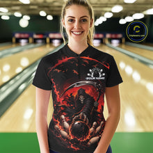 Load image into Gallery viewer, Front view of a female model wearing a black and red bowling quarter zip shirt showcasing a grim reaper reaching through swirling flames to command a blazing bowling ball striking scattered pins in a bowling lane.