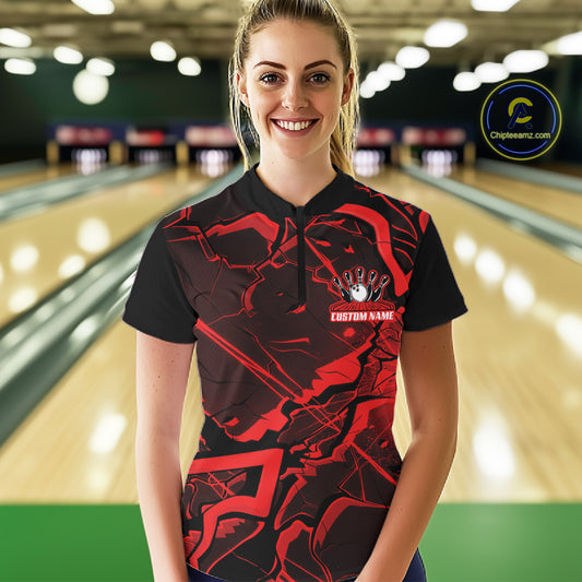 Female model wearing a black and red bowling quarter-zip at the bowling alley with angular geometric graphics.