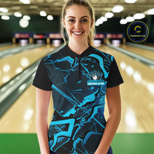 Load image into Gallery viewer, Female model in a bowling lane wearing a black and blue quarter-zip with futuristic geometric artwork.