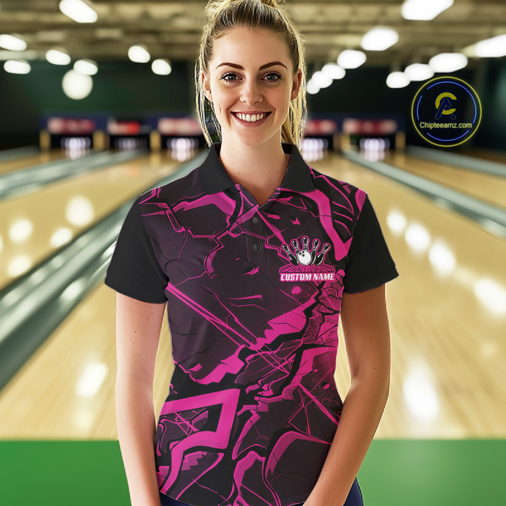 Female model wearing a black and pink bowling polo in a bowling center with futuristic cracked graphics.