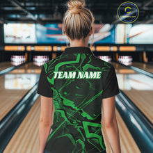 Load image into Gallery viewer, Back view of a womens black and green bowling polo showcasing sharp angular lines and futuristic pattern details.
