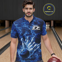 Load image into Gallery viewer, Male model at the bowling lane wearing a bowling polo with blue bowling ball artwork and fiery graphics.