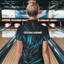 Load image into Gallery viewer, Back view of a female model in a bowling alley wearing a black and turquoise blue quarter-zip shirt featuring a patriotic flaming bowling ball striking pins over a distressed American flag.