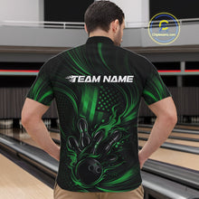 Load image into Gallery viewer, Front view of a male model in a bowling center wearing a black and green quarter-zip shirt featuring flaming bowling ball artwork and patriotic pin graphics.