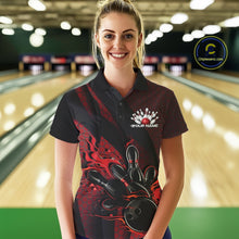 Load image into Gallery viewer, Female model wearing a black and red bowling polo shirt at a bowling lane with fiery bowling action artwork and geometric styling.