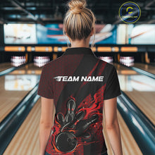 Load image into Gallery viewer, Back view of a female model in a bowling center wearing a black and red polo shirt featuring a flaming bowling ball and pin design.