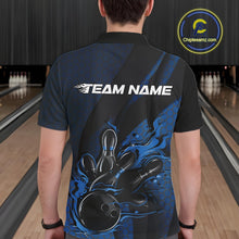 Load image into Gallery viewer, Back view of a male model in a bowling alley wearing a black and blue polo shirt featuring a bowling strike motif with flame effects.