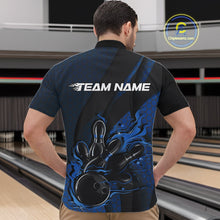 Load image into Gallery viewer, Front view of a male model in a bowling alley wearing a black and blue quarter-zip shirt featuring a flaming bowling ball knocking down pins.