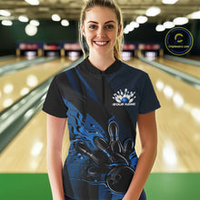 Load image into Gallery viewer, Female model in a bowling lane wearing a black and blue quarter zip shirt, front view showcasing fiery bowling ball knocking down pins with dynamic geometric artwork