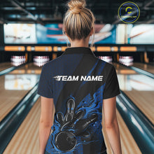 Load image into Gallery viewer, Female model inside a bowling center, back view of black and blue quarter zip shirt highlighting flames bowling ball striking pins with structured hexagon and stripe patterns