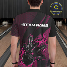 Load image into Gallery viewer, Back view of a male model in a bowling venue wearing a black and pink polo shirt featuring a fiery bowling action graphic.