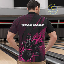 Load image into Gallery viewer, Front view of a male model in a bowling venue wearing a black and pink quarter-zip shirt featuring a flaming bowling ball hitting the pins.