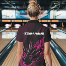 Load image into Gallery viewer, Female model inside a bowling center, back view of black and pink quarter zip shirt highlighting fiery bowling ball striking pins with abstract patterned details