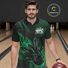 Load image into Gallery viewer, Male model wearing a black and green bowling polo shirt at a bowling lane with fiery bowling artwork, geometric patterns, and diagonal striping.