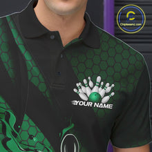 Load image into Gallery viewer, Close-up of the left chest on a black and green bowling polo shirt featuring a flaming bowling ball and pin motif with geometric details.
