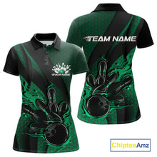 Load image into Gallery viewer, Front and back display of a black and green women’s bowling polo shirt featuring a flaming bowling ball striking pins, hexagon graphics, and diagonal stripes.