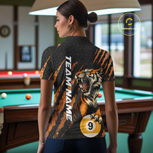 Load image into Gallery viewer, Female model back view wearing a polo shirt with roaring tiger graphics, billiard balls, and orange claw marks.