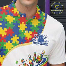 Load image into Gallery viewer, Close-up left chest detail of white bowling polo shirt showcasing colorful autism bowling strike emblem with puzzle-inspired graphics
