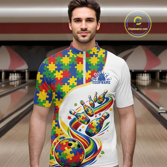 In Bowling Lane, Front View Male Model Wearing White Quarter-Zip Shirt Featuring Autism Puzzle Bowling Strike Artwork With Colorful Graphic Accents