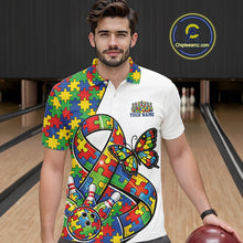 Load image into Gallery viewer, Male model in a bowling lane wearing a white polo shirt, front view featuring autism puzzle ribbon, butterfly, and bowling ball striking pins design