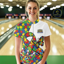 Load image into Gallery viewer, Female model in a bowling lane wearing a white quarter-zip shirt, autism ribbon and butterfly artwork with bowling ball striking pins design.