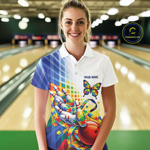 Load image into Gallery viewer, Female model in a bowling alley, front view wearing white and blue polo shirt featuring puzzle butterfly bowling artwork and ribbon accents