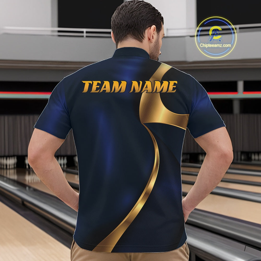 A man viewed from behind wearing a custom bowling shirt with a dark blue and gold graphic design and 'TEAM NAME' printed on the back, set against a bowling alley background.