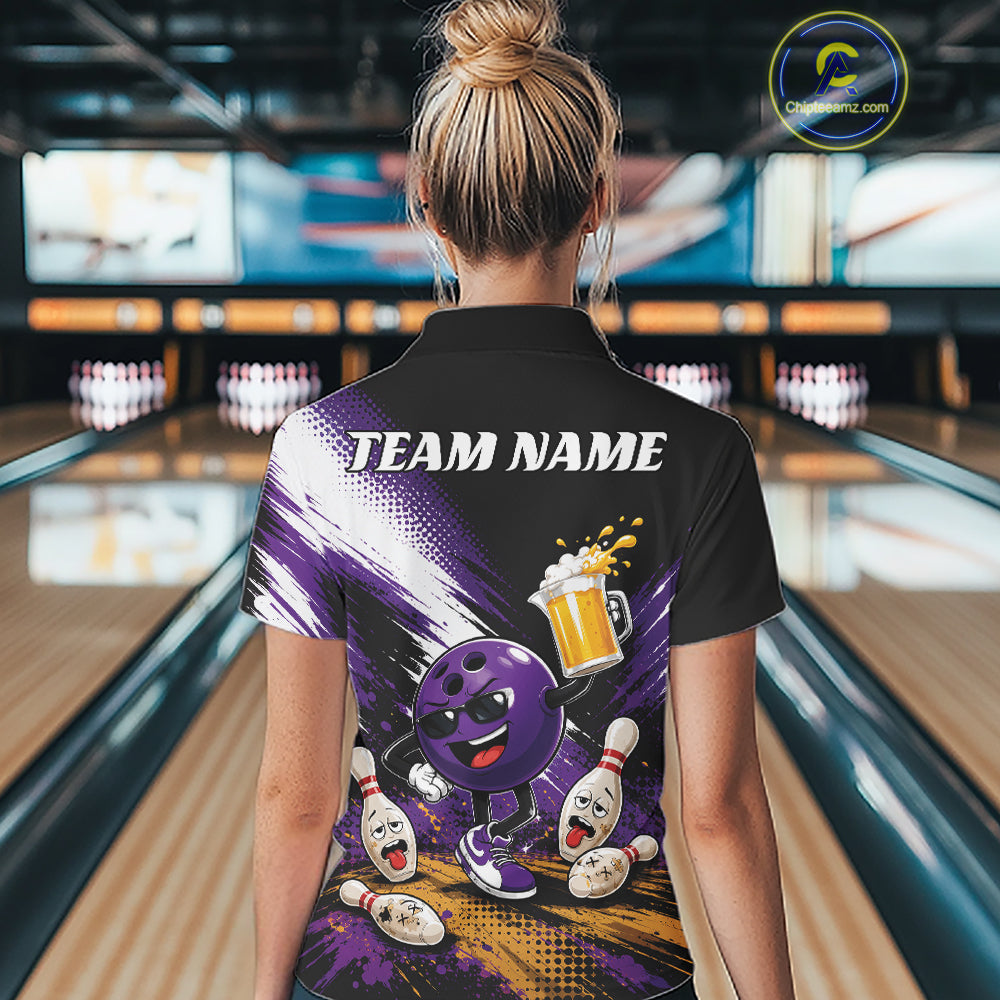 A woman viewed from behind wearing a black short-sleeve bowling polo shirt with a colorful purple and gold graphic design on the back, standing in a bowling alley.
