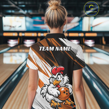 A woman viewed from behind wearing a custom bowling shirt in a bowling alley. The shirt features a black, red, and white graphic design with a cartoon chicken mascot holding a red bowling ball and the text 'TEAM NAME' printed across the upper back.