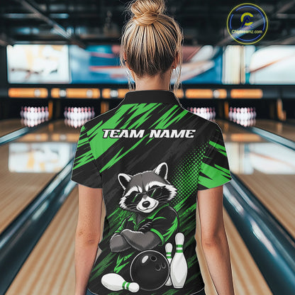 A woman viewed from behind wearing a short-sleeve bowling polo shirt with a raccoon graphic and the text 'TEAM NAME' on the back, standing in a bowling alley.