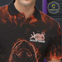 Load image into Gallery viewer, Close-up view of the left chest area of a black bowling polo shirt showing glowing orange electric panther with bowling ball crashing through pins detail.