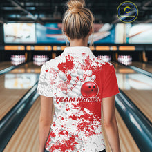 Load image into Gallery viewer, Back view female model at bowling lane wearing white polo with red and white splatter background, relaxed pose in bowling venue