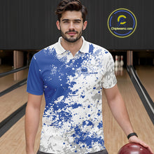 Load image into Gallery viewer, Front view of a male model in a bowling lane wearing a blue and white splatter polo shirt with minimalist bowling-inspired graphics.