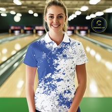 Load image into Gallery viewer, Female model front view at bowling lane wearing white polo shirt with blue and white splatter pattern, casual sporty bowling center environment