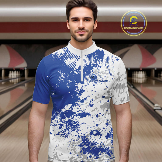 Male model in a bowling lane wearing blue and white quarter zip shirt, front view showcasing blue splatter pattern with minimal modern design