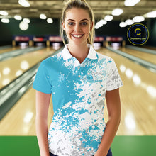 Load image into Gallery viewer, Female model front view at bowling lane wearing white polo shirt with teal blue and white splatter pattern, sporty bowling venue scene
