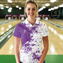 Load image into Gallery viewer, Female model front view at bowling lane wearing white polo shirt with purple and white splatter design, sporty bowling center scene