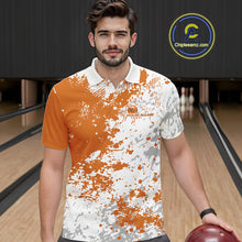 Load image into Gallery viewer, Front view of a male model in a bowling lane wearing an orange and white splatter polo shirt with clean athletic bowling visuals.