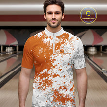 Load image into Gallery viewer, Male model in a bowling lane wearing orange and white quarter zip shirt, front view showcasing orange splatter pattern with simple abstract sportswear styling