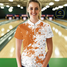 Load image into Gallery viewer, Front view of a female model in a bowling lane wearing a bowling quarter-zip shirt with orange and white splatter background and dynamic athletic styling.